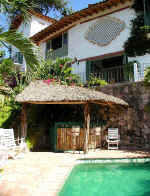 Pool and deck with palapa bar, Main house on right and casita on the left