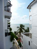 partial ocean and beach view from condos balcony