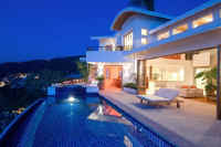 villa Ventana main floor with pool and living room at night