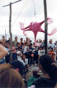 trying to break the pinata at the beach